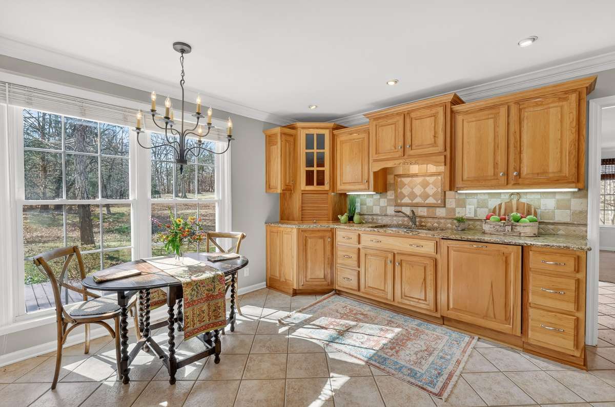 Granite countertops and tile backsplash and loads of cabinetry
