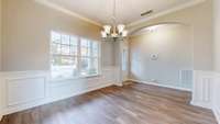 Formal dining room or sitting room at the front of them home. This room has access to the kitchen and front door.