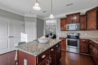 Double Doors lead to Laundry Space, adjacent is a half bath.