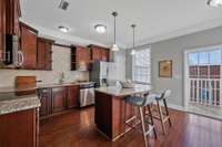 Great Kitchen! Granite counters, lots of cabinet storage, island for baking/bar, small balcony.