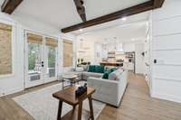 Spacious living room with gas fireplace, large windows, and open flow to the kitchen and screened porch. The perfect central gathering space for everyday living or entertaining friends and family.