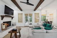 The living room’s cozy gas fireplace is framed by striking tile accents. Enjoy fireside evenings in this inviting space that blends comfort and style with direct backyard and porch access.