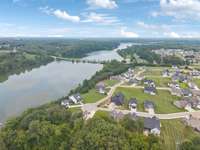 Another neighborhood aerial emphasizing surrounding green space, community charm, and lake access. Great visual of the balanced, peaceful environment.