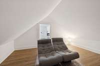 Upstairs bonus room with neutral finishes and natural light. Perfect as a playroom, home theater, craft space, offering endless possibilities for modern living.