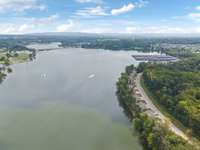Expansive aerial of Tims Ford Lake with boats in action. Captures the vibrant, active lifestyle available right outside the Twin Creeks neighborhood.
