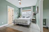 Another generously sized upstairs bedroom with neutral tones and bright windows. An inviting retreat that can adapt easily as a guest room, nursery, or hobby space.