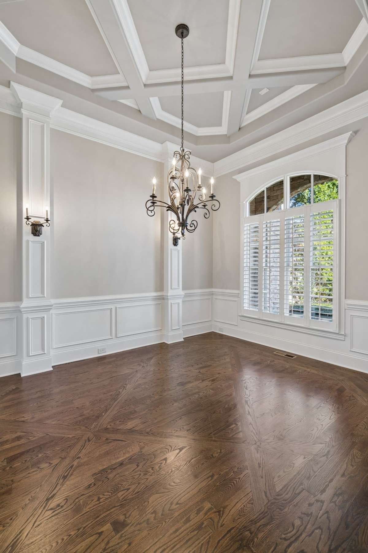 Dining room features special ceiling treatment, wainscotting, shutters and sconces to make this room special!