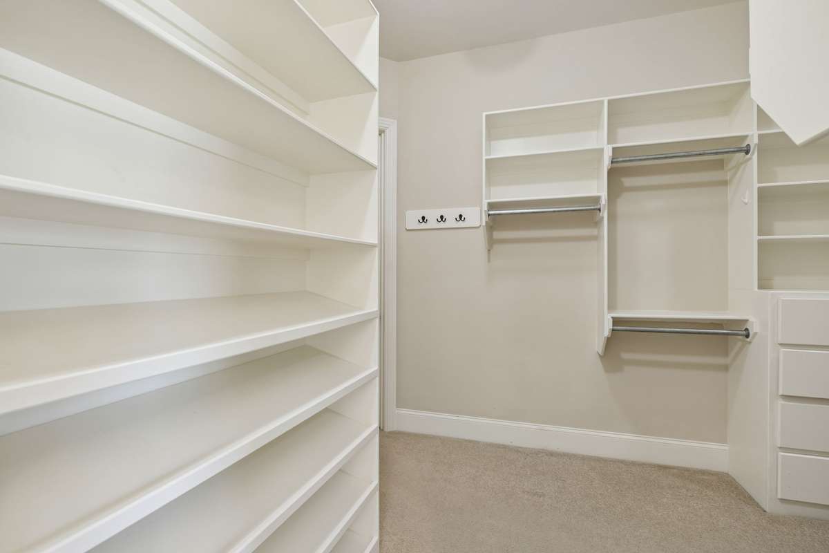 Primary closet has door leading directly to laundry room.
