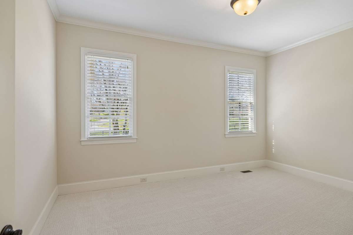 Fourth bedroom.  One opposite side of house from other bedrooms.  Lends itself to perfect mother in law plan.   This bedroom is larger than it appears in the photograph.  Can enter through pedestrian door in garage for privacy.