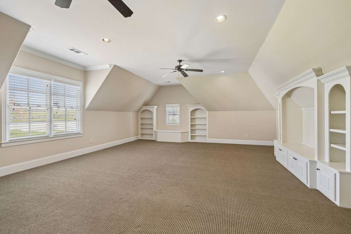 Built in cabinets in this large bonus room.