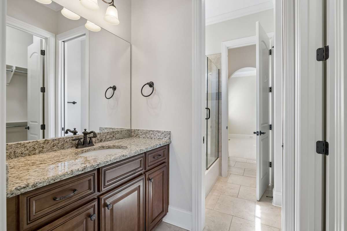 Jack & Jill bath featuring tub/shower combo, each side has it's own vanity.
