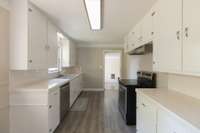 The kitchen has new LVP flooring, dishwasher, oven, sink and fresh paint.