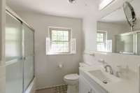 The bathroom has good light, new toilet, vanity and hardware.