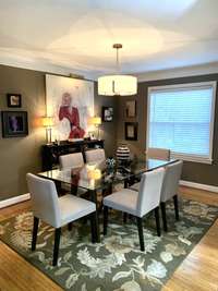 Wood floors and crown moulding continue into the dining room.