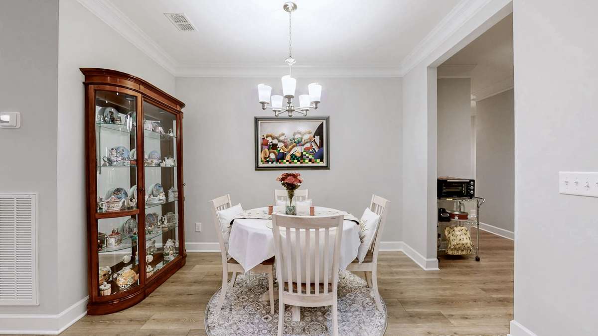Dining area leads to the laundry room and stairs to the bonus room upstairs.
