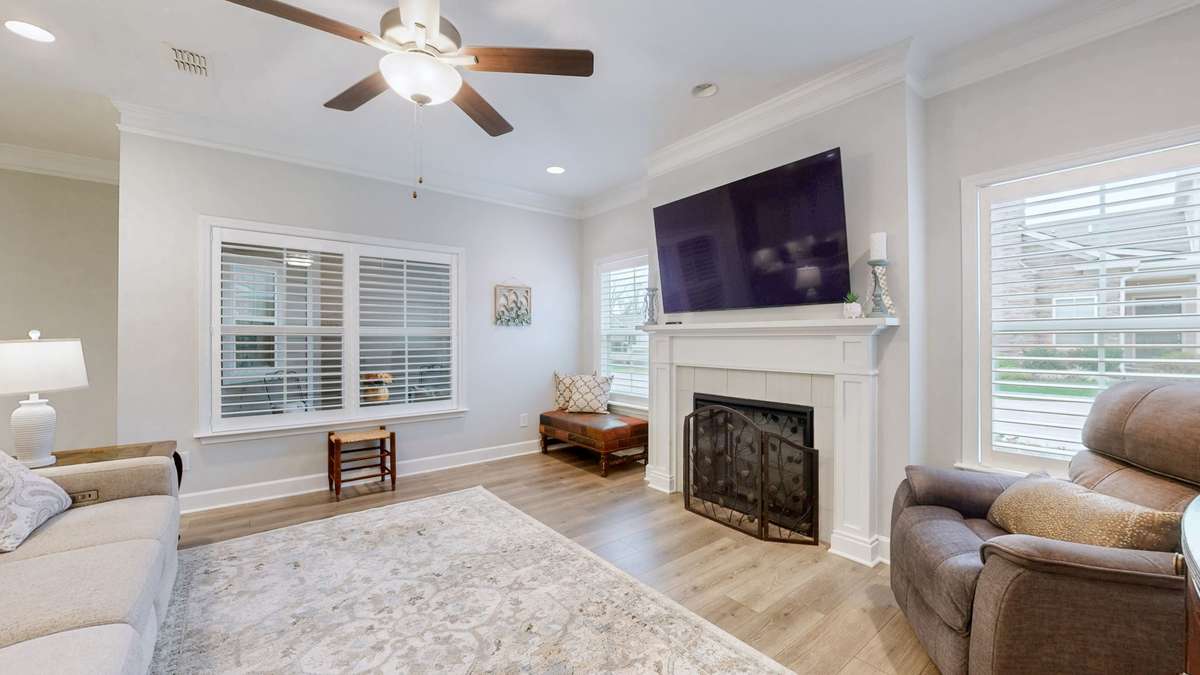 The beautiful LVP floors and electric fireplace add to the warmth of your new home.