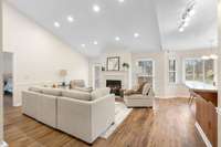 Family room with vaulted ceilings with cozy fireplace.