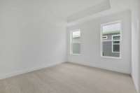 Your primary suite features a tray ceiling and your own private bathroom.