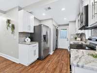 The Kitchen space is easy to navigate and has a pantry and stackable washer and dryer which convey with the home.