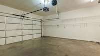 Garage, insulated garage doors, extra power source and custom shelving and overhead racks for storage