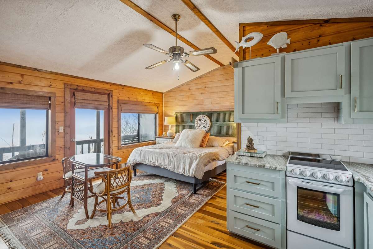 "In-law" suite, with kitchenette, bath, and private balcony. This space has a private entrance separate from the main living space.