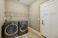 Spacious laundry room with a utility/coat closet. Door pictured is entry from garage.