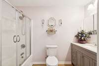 This fully renovated guest bathroom offers a spacious layout with a stylish enclosed shower and tub—combining contemporary design with everyday functionality.