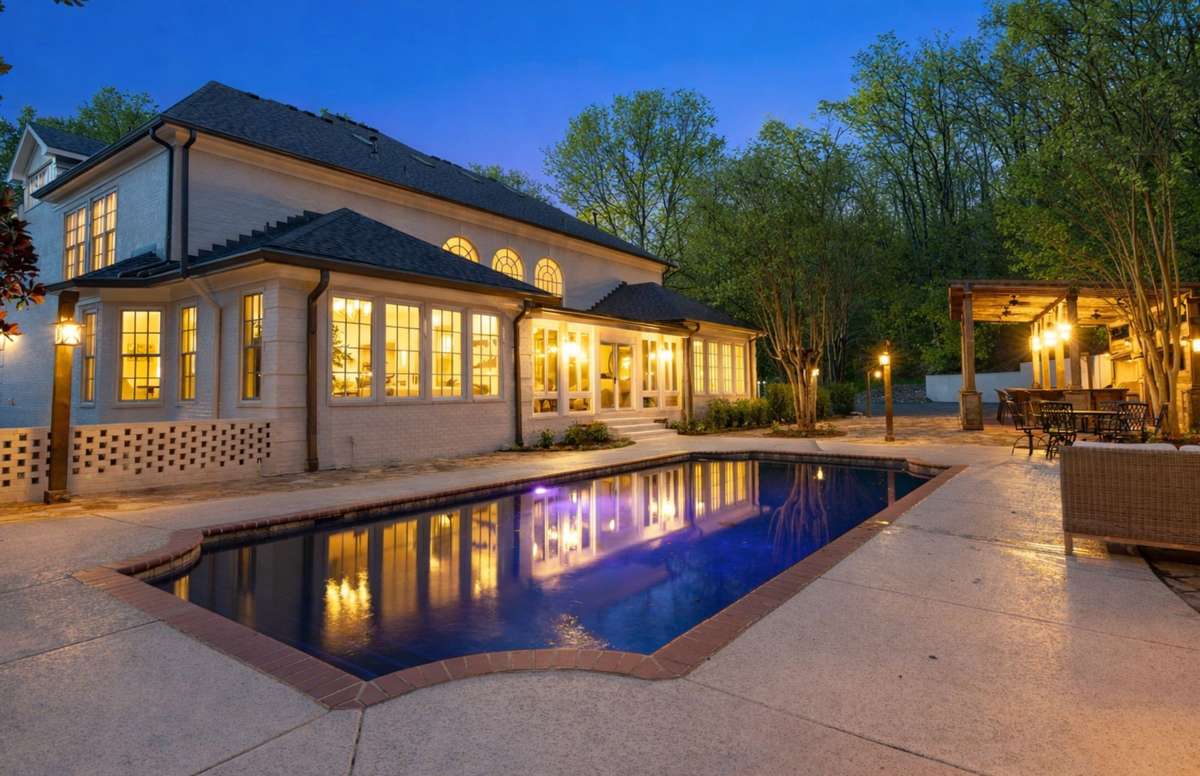 Heated pool and outdoor living area with bath house and kitchen