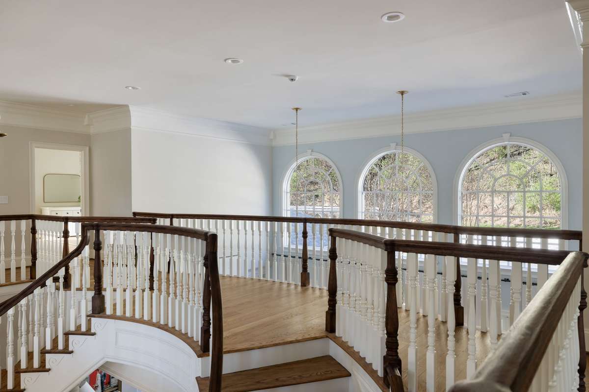 Upper landing overlooking the two-story foyer and dining room