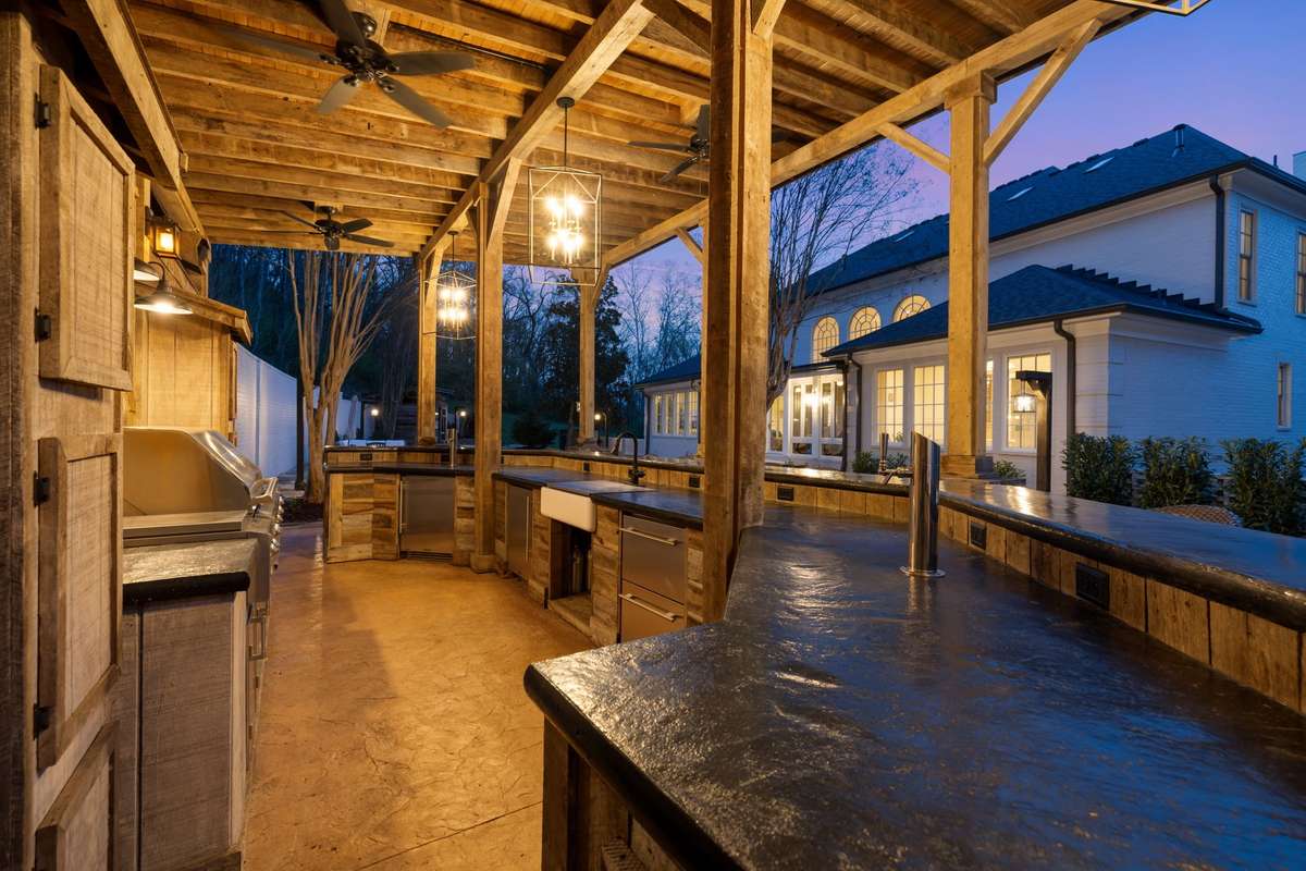 Outdoor kitchen with grilling station and bar seating for 14 people