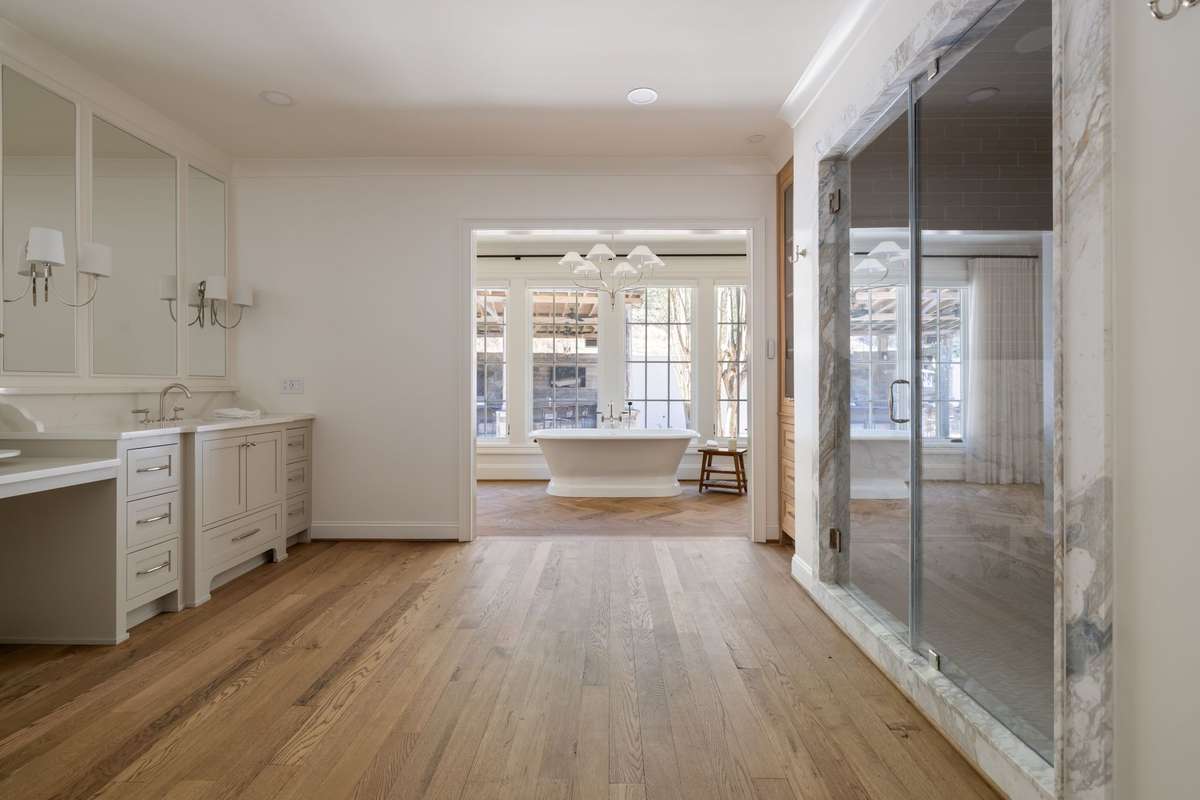 Primary bath with dual vanities and custom cabinetry
