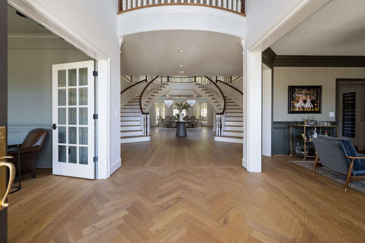 Central gallery with herringbone flooring connecting the main spaces