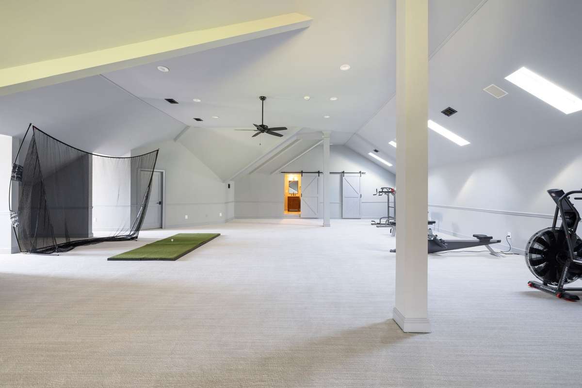 Expansive third floor recreation space with powder bath