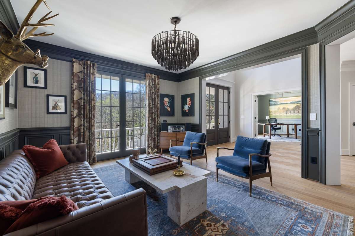 Elegant sitting room with natural light and front porch access