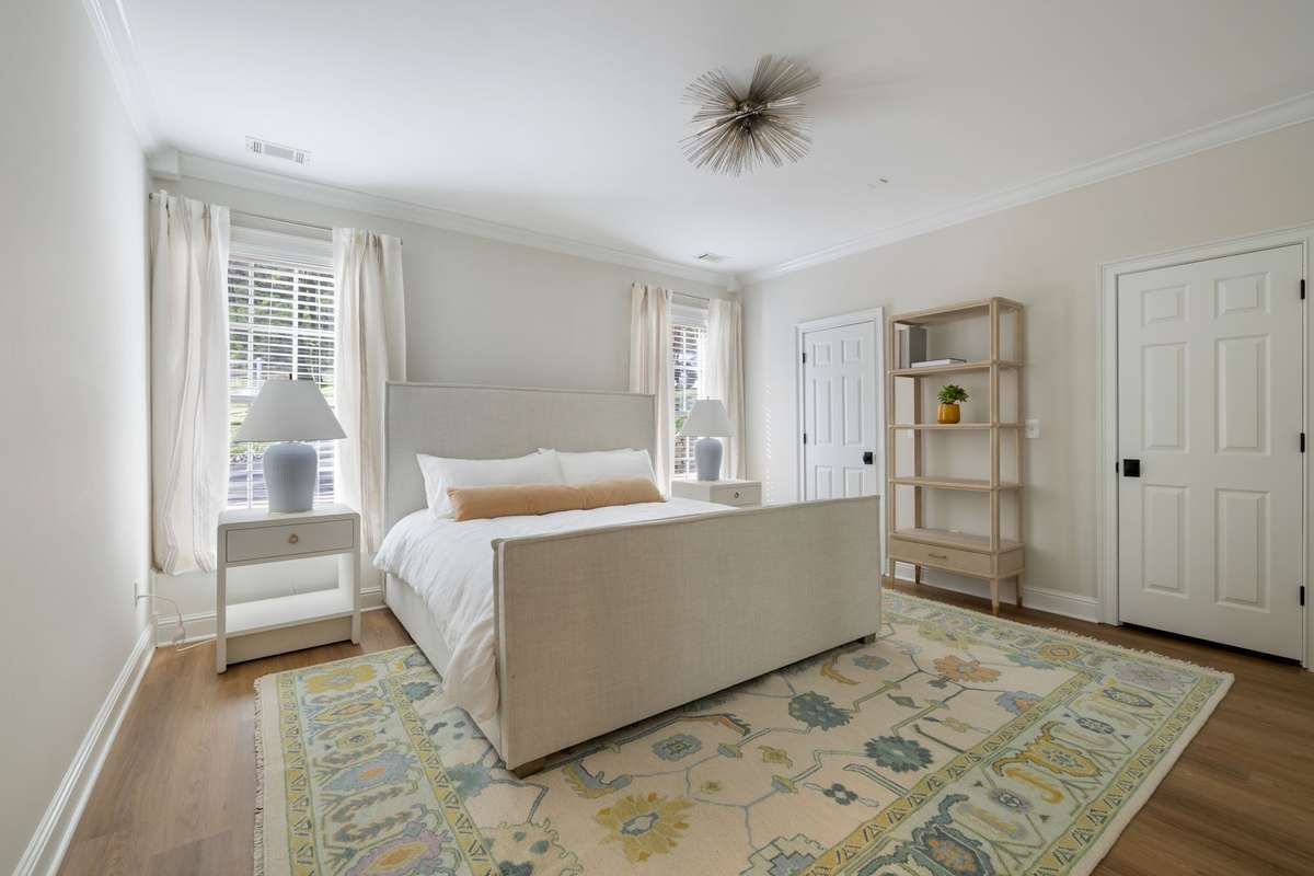 Lower-level bedroom with natural light, ideal for private guest or multigenerational living