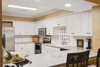white cabinets and stainless steel appliances in the kitchen