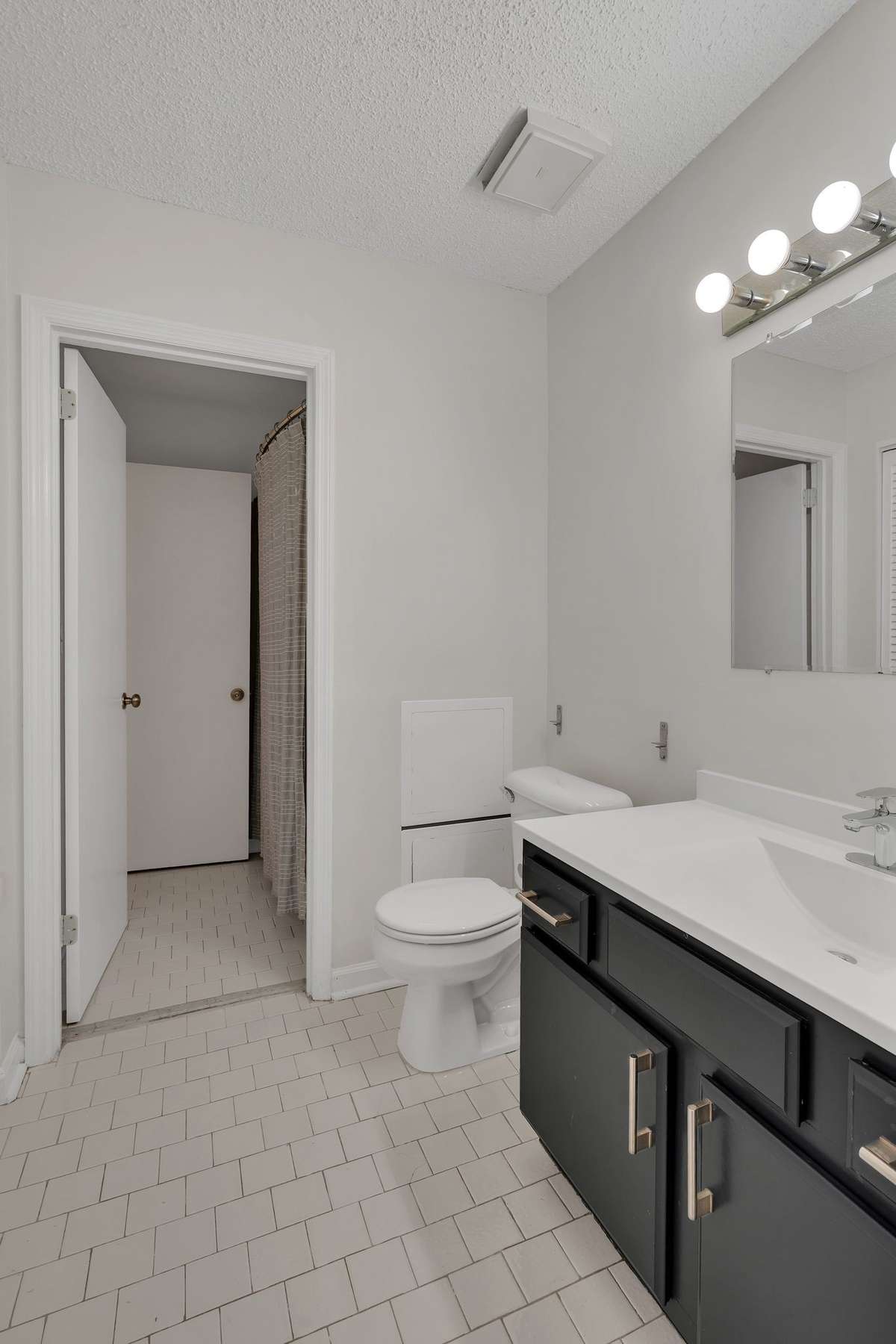 Half bath for guests connects to main bathroom