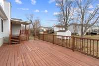 This area leads to a spacious uncovered deck ideal for hosting gatherings, outdoor dining, or quiet evenings at home.