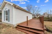 A raised additional deck area provides another space for relaxation and connects elegantly back toward the front yard, creating a beautifully flowing outdoor environment.