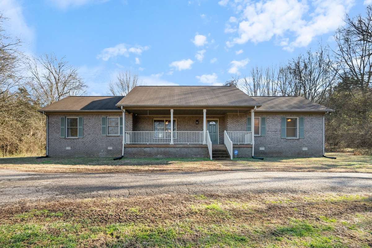 front view sitting on 7 + private acres completely private half open land /half wooded privacy sits out of view from main road   All brick freshly painted trim