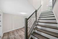 Staircase with laminate treads & railing to give this house a modern look.