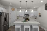 The Large Kitchen Island Boasts Extra Seating for Friends and Family Alike.