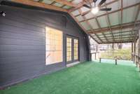 The deck offers shaded outdoor space, scenic views through the trees, with a ceiling fan with overhead lighting, and a comfortable space for year-round comfort to enjoy fresh air in any season.