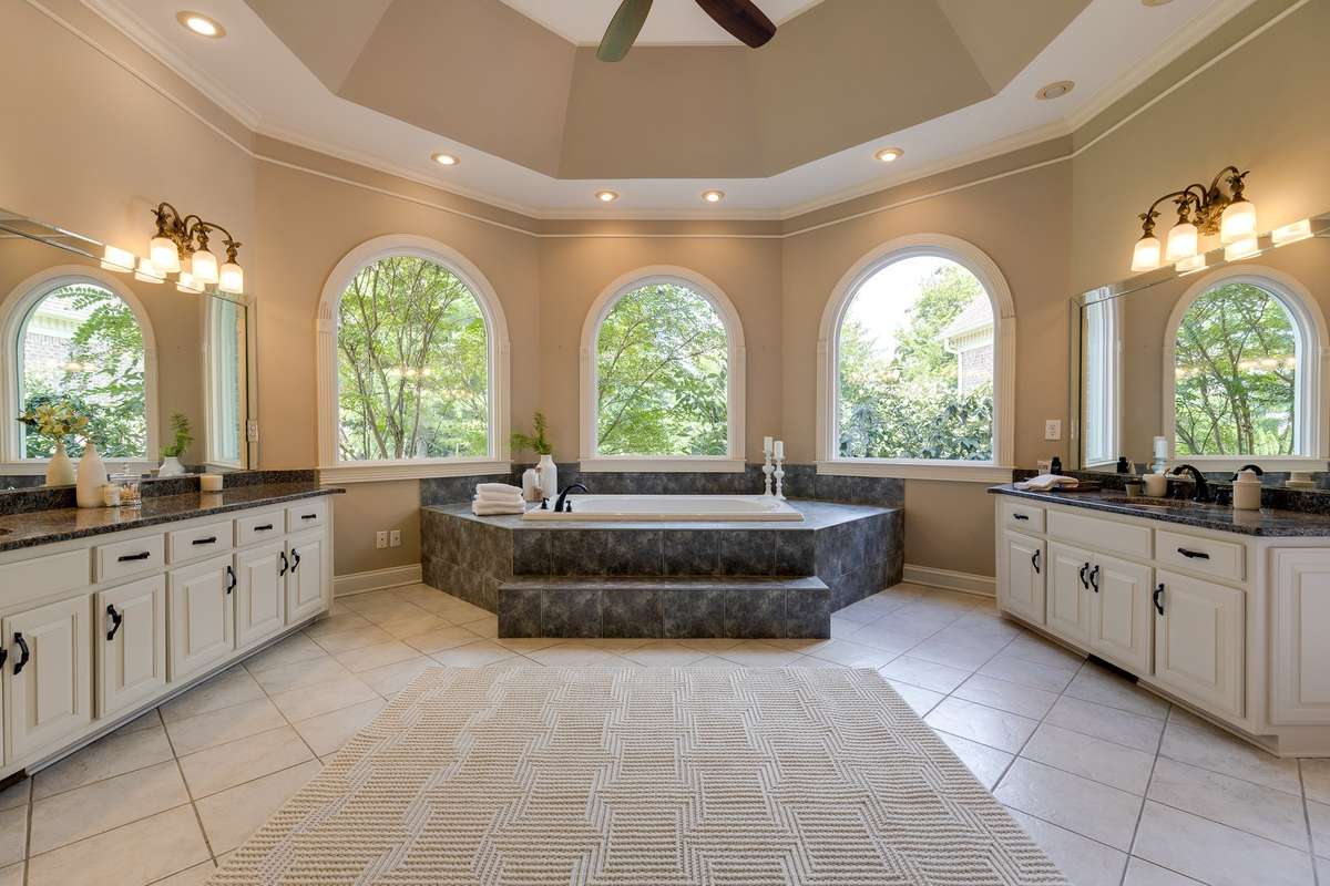 master bathroom with his and her vanities and picture windows