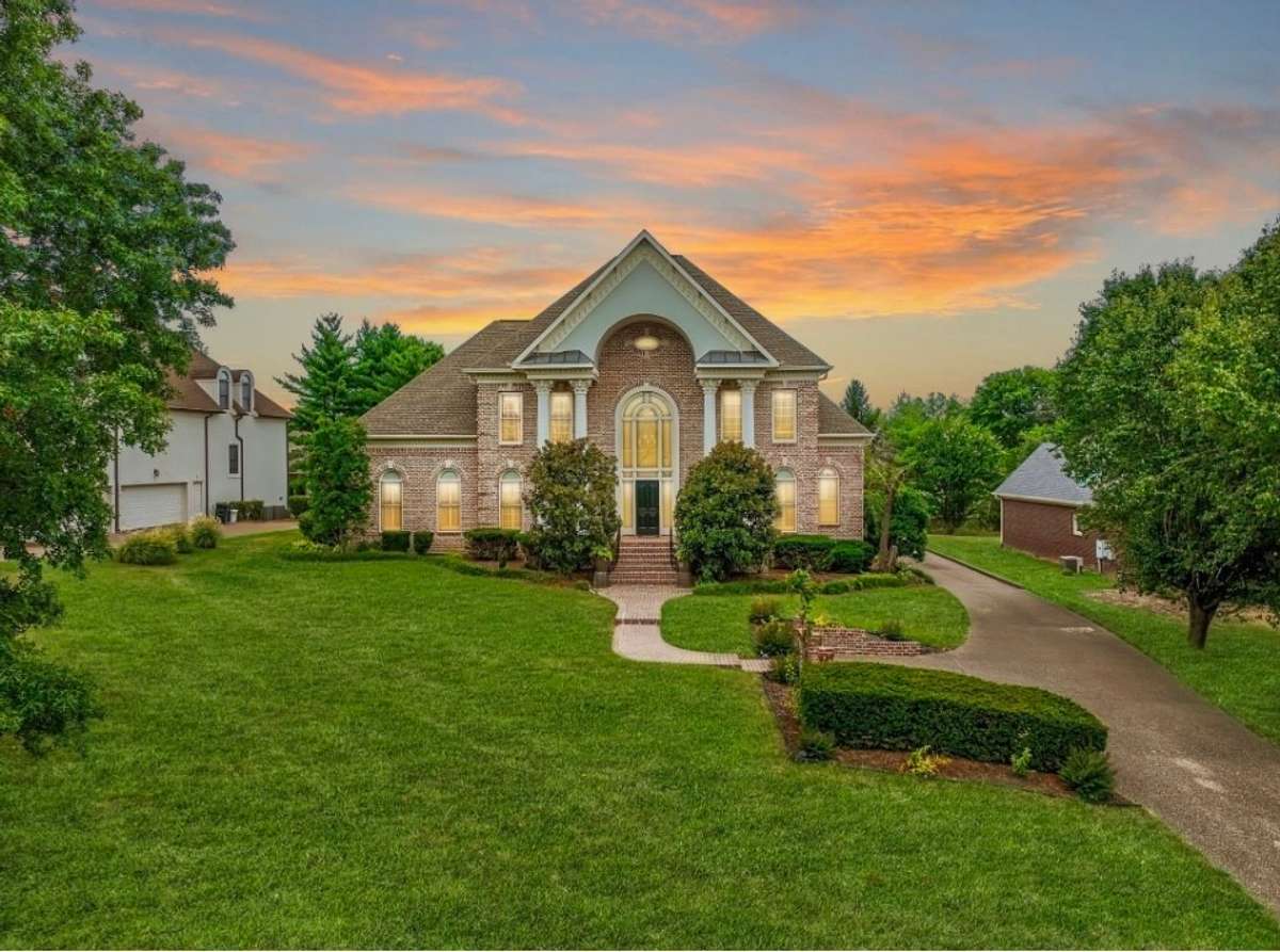twilight view of the stately all brick house