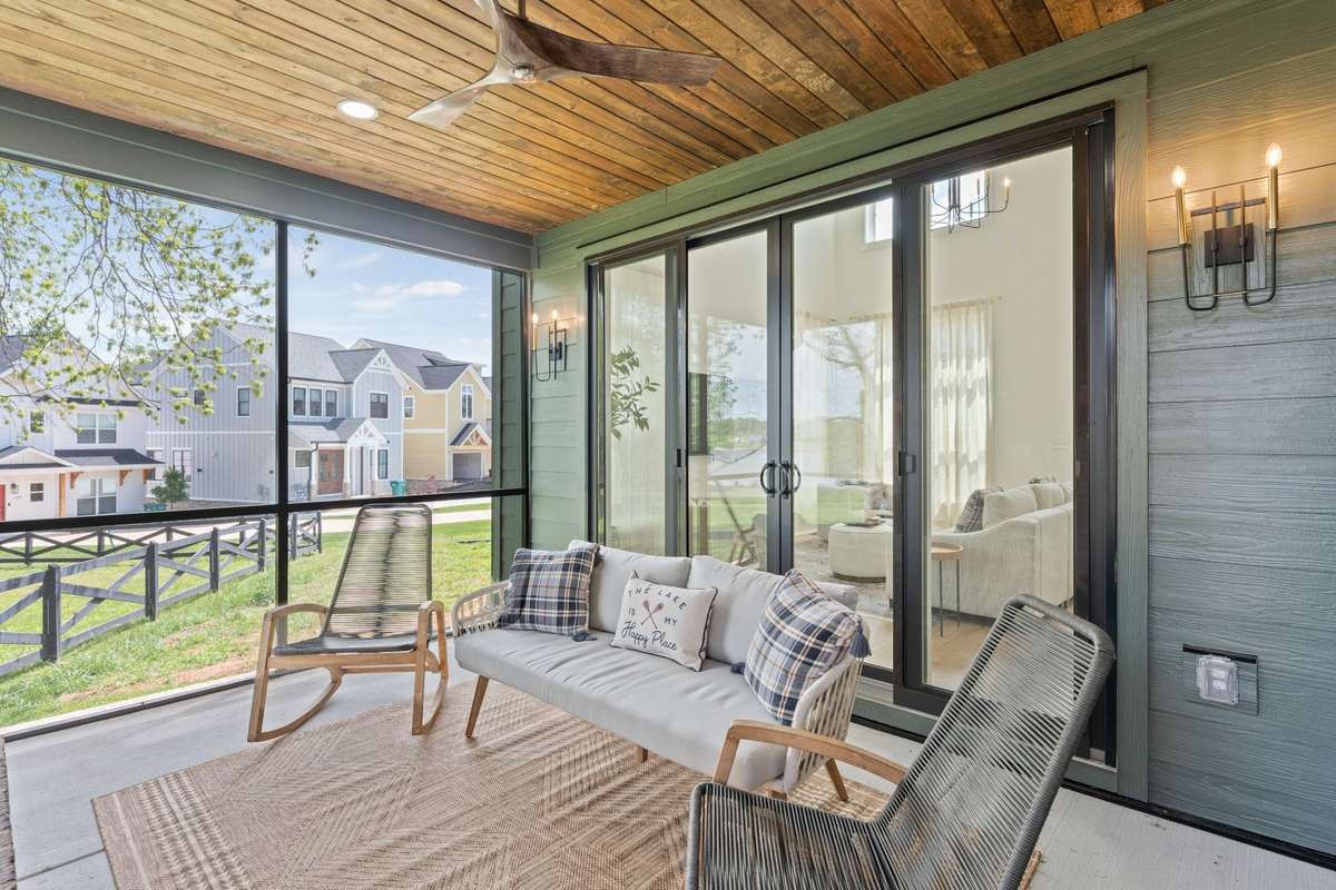 Wood ceiling and ceiling fan on the screened in porch