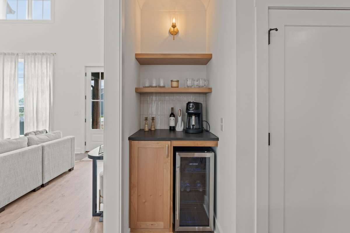 Breakfast bar and separate wine cooler enhance entertaining flow outside the main kitchen