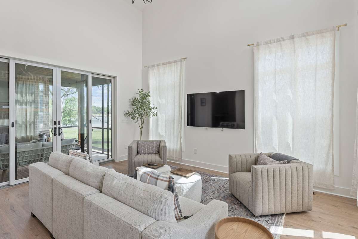 Double french doors lead to screened in porch- keep them open for adding living space