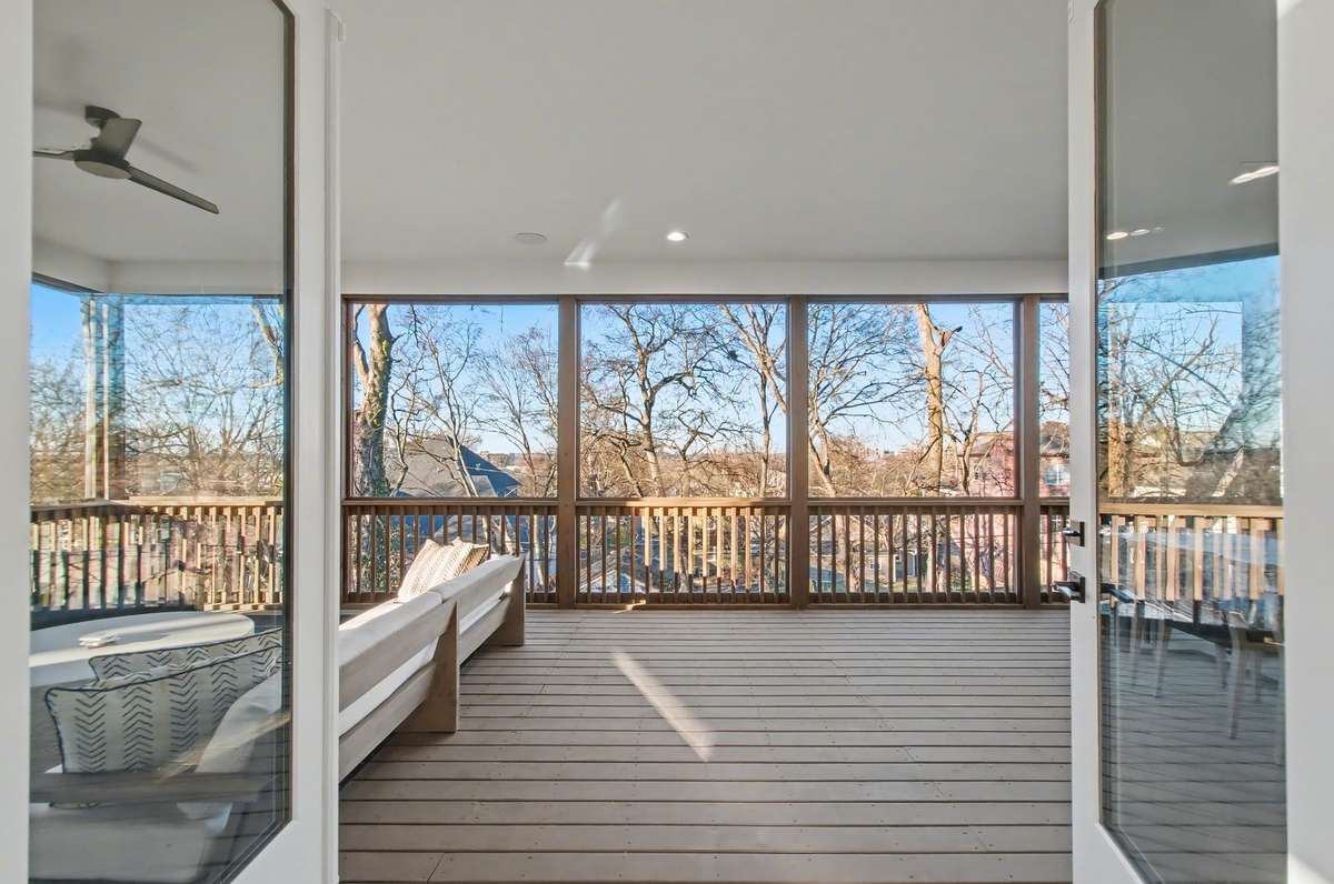 Double doors lead to screened in deck!