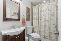 This home’s downstairs bathroom is designed for both convenience and comfort. Featuring a combo tub and shower, it offers flexibility for everyday routines, while the whirlpool tub provides the perfect retreat for unwinding after a long day.